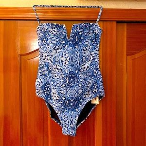Brand new, never worn. One piece bathing suit with detachable, adjustable halter